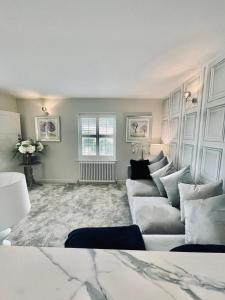 a living room with a couch and a window at Cotswold Chic Retreats "Cloud Nine" 5 Star Chipping Campden-Parking-Garden in Chipping Campden