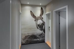 a painting of a giraffe on a wall at Boutique Hotel Stanserhof in Stans