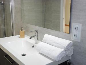 a bathroom with a sink with towels on it at Apartamento Dayok Costa Barcelona in Malgrat de Mar