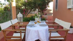 a table with glasses of wine on top of it at Villa titika in Argostoli