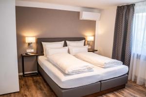 Posteľ alebo postele v izbe v ubytovaní CityApartments Residence klimatisiert