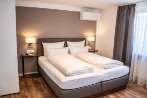 Postel nebo postele na pokoji v ubytování CityApartments Residence klimatisiert