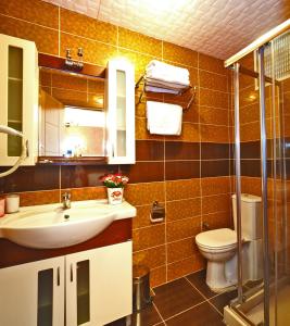 a bathroom with a sink and a toilet at The Sunrise Hotel in Istanbul