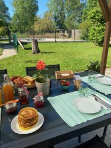 a blue table with pancakes and other food on it at Chambre d'Hotes La Chaiserie in Romeries