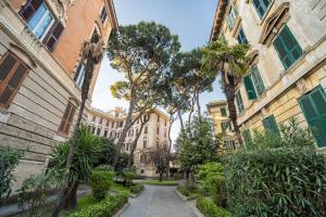 a street in a city with palm trees and buildings at Sweet Home Pigneto Guest House in Rome