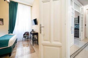 a bedroom with a bed and a sliding door at Sweet Home Pigneto Guest House in Rome