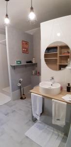 a white bathroom with a sink and a mirror at Chambre d'hôtes du Mas Julianas in Saint-Laurent-de-la-Salanque +24 photos