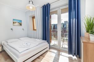 Posteľ alebo postele v izbe v ubytovaní Apartamenty Feniks by Noclegi Renters