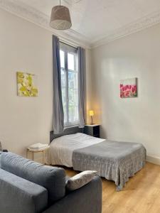 パリにあるStudio Poisson 1のベッドルーム1室(ベッド1台、ソファ、窓付)