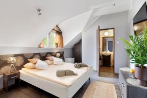 a bedroom with a large white bed in a room at Guesthouse Baltic in Gdańsk