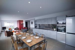 a kitchen and dining room with a table and chairs at Appartement Tournette - Vue Lac in Sévrier