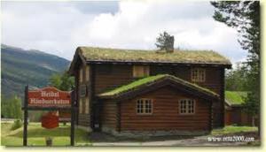 a log cabin with a sign in front of it at Lusæter Timber Cabins in Heidal