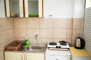 a small kitchen with a sink and a stove at 4 Studios Becic in Budva +32 photos