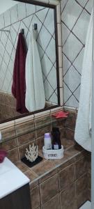 a bathroom with a mirror and towels at Balancon Playa Cabezo in El Médano