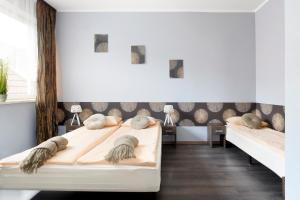 a bedroom with two beds with pillows at Guesthouse Baltic in Gdańsk