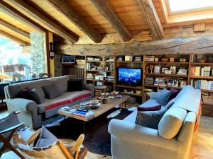 a living room with two couches and a tv at Maison Fort Bovet #Bluchalet in La Salle