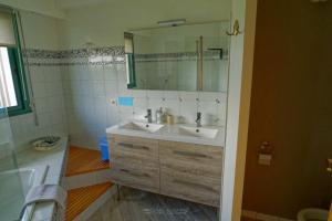 a bathroom with a sink and a mirror at Guest house Chante vent in Douarnenez