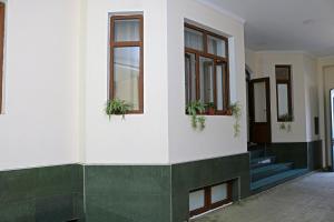 a building with potted plants on the side of it at Chinor Garden Hotel - Free Airport Pick-up and Drop-Off in Tashkent