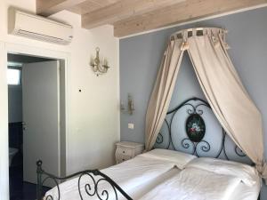 a bedroom with a white bed with a canopy at Agriturismo Maso Bergot in Arco