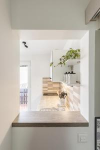 a kitchen with white walls and a wooden counter top at Pod Koblo Bohinj Apartments in Bohinj