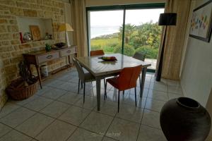 a dining room with a table and chairs and a window at Guest house Chante vent in Douarnenez +28 photos