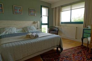 a bedroom with a bed with two slippers on it at Guest house Chante vent in Douarnenez