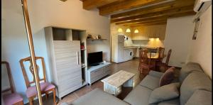 a living room with a couch and a kitchen at Cal Ginés in Llimiana