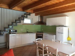 a kitchen with a table and a staircase at Agriturismo Maso Bergot in Arco