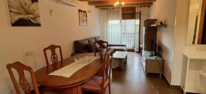 a dining room with a table and chairs and a living room at Cal Ginés in Llimiana