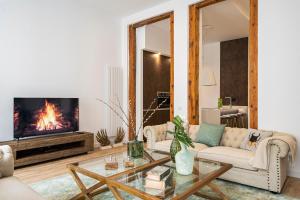a living room with a couch and a fireplace at Ever House - El CORAZON de CHUECA in Madrid