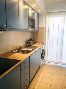 a kitchen with a sink and a washing machine at Marina Club Lagos Resort in Lagos