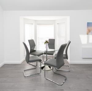 a dining room with a table and four chairs at 107 Eglinton Street in Portrush
