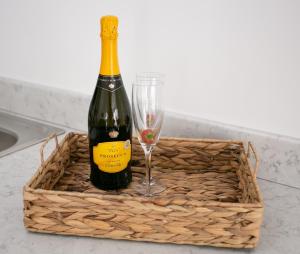 a bottle of wine and a glass in a basket at 107 Eglinton Street in Portrush