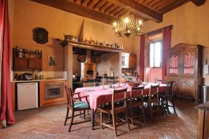 a dining room with a table and chairs in a kitchen at Castello Di Potentino in Seggiano
