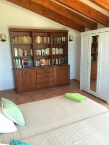 a bedroom with a large bed and a book shelf at BINIALMESC in Alaior