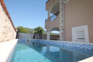 a swimming pool in a villa with a house at Apartment with pool Tomic Boka Bay in Herceg-Novi