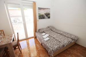a bedroom with a bed and a table and a window at Apartment with pool Tomic Boka Bay in Herceg-Novi +36 photos