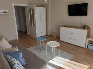 uma sala de estar com duas cadeiras e uma televisão em Helski em Hel