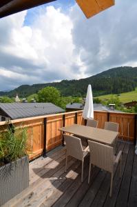 a patio with a table and chairs on a deck at Sweet Dreams Appartements in Going am Wilden Kaiser