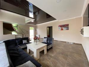 a living room with a couch and a table at PALAZZO in Tbilisi City