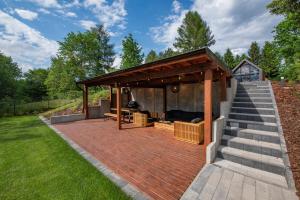 a pavilion with a deck and stairs at NATERIA DOMEK NAD JEZIOREM in Nattern