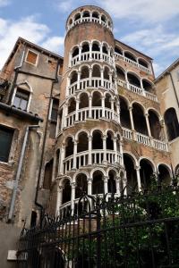 a tall building with a tower in front of it at Palazzo Eugenia - Minelli in Venice