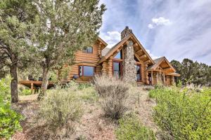 a log home in the woods with trees at Spacious Mountain Retreat with Deck Hike and Explore! in Glenwood Springs