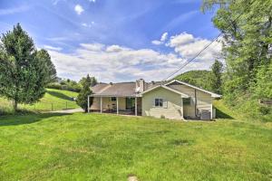 a house on a hill with a green yard at Bluefield Retreat with Pool Table Near Parks! in Bluefield