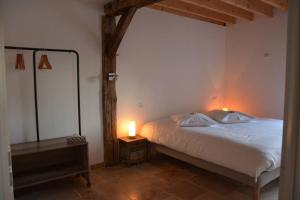 a bedroom with a bed with two lamps on it at Corps de Ferme Labarthe à Pimbo in Pimbo +31 photos
