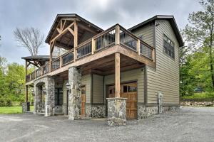 a house with a wrap around porch with a wrap around deck at Elegant Mtn Chalet with Deck 1 Mi to Mt Snow! in Dover