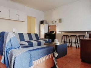 a living room with a couch and a kitchen at Ambiente Budget Accommodation in Upington