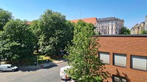 a brick building with cars parked in a parking lot at TopDomizil Apartments Berlin Mitte in Berlin