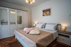 a bedroom with a bed with two pillows on it at House Nada apartman in Muntić
