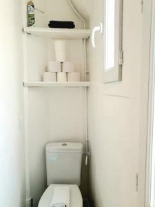 a small bathroom with a toilet and some towels at Bright & Modern Studio With Great Sun Exposure in Paris
